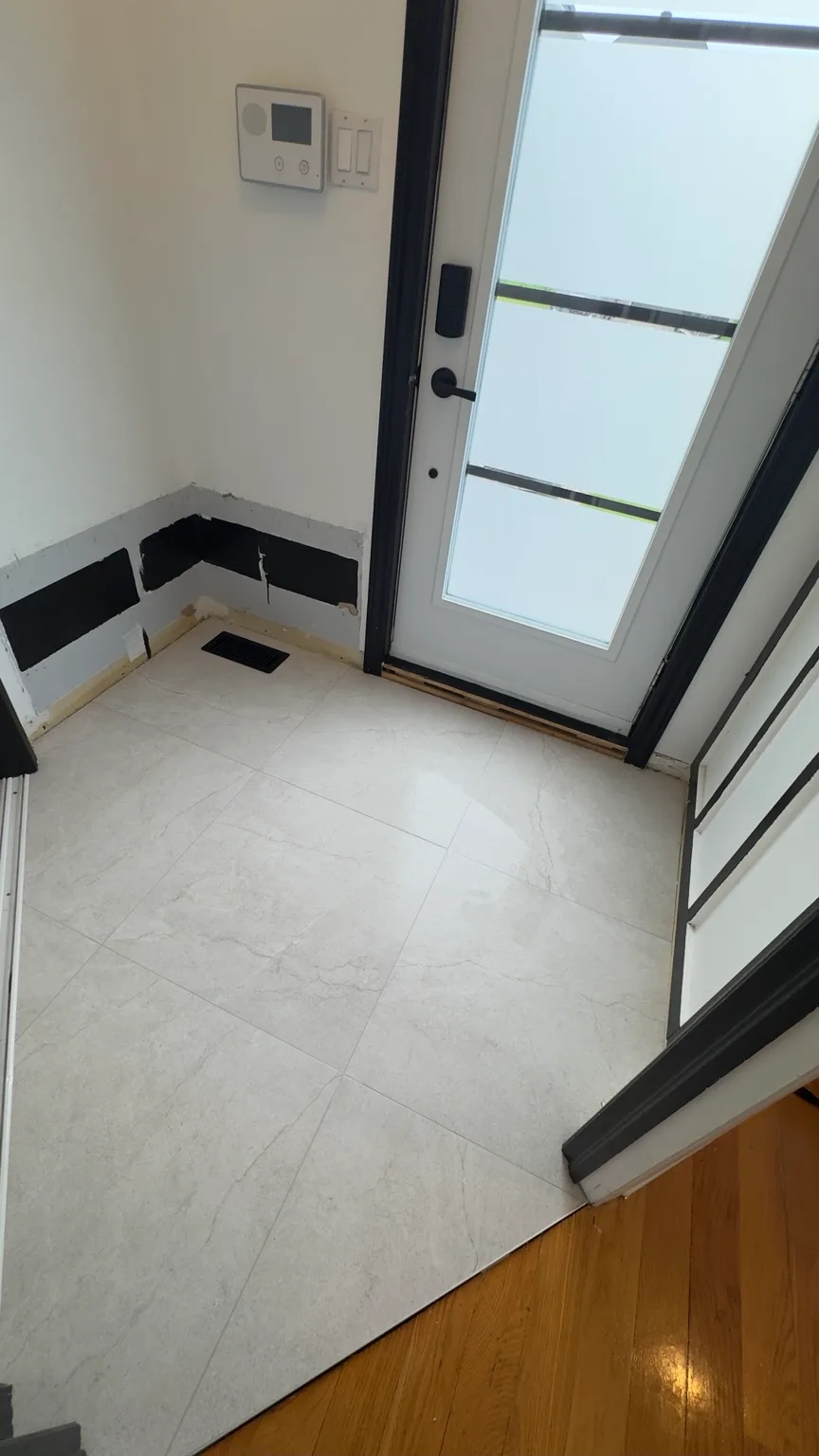 Detail of the completed porcelain floor in the entryway.