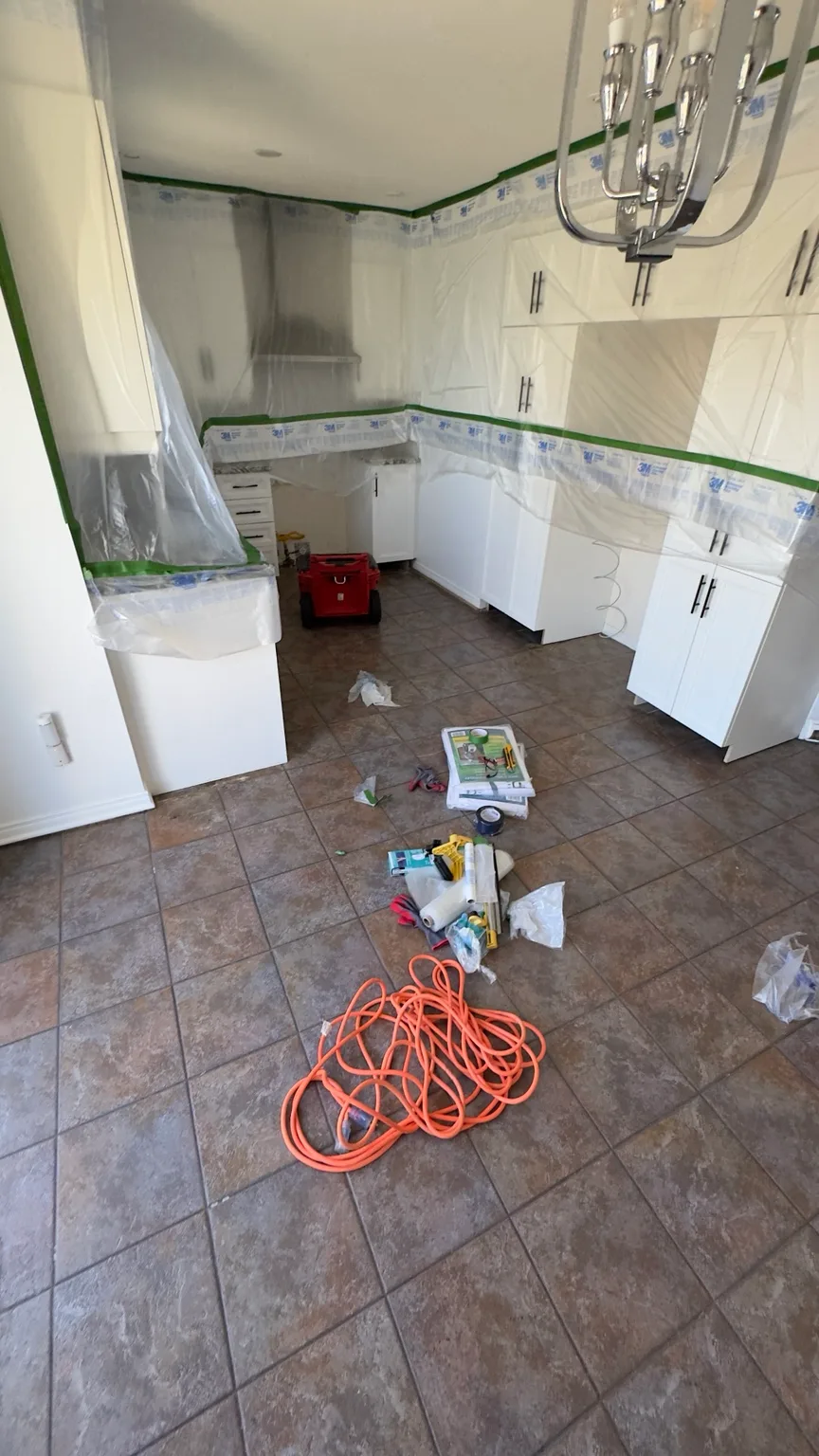 Protection of cabinets and adjacent elements before flooring work.