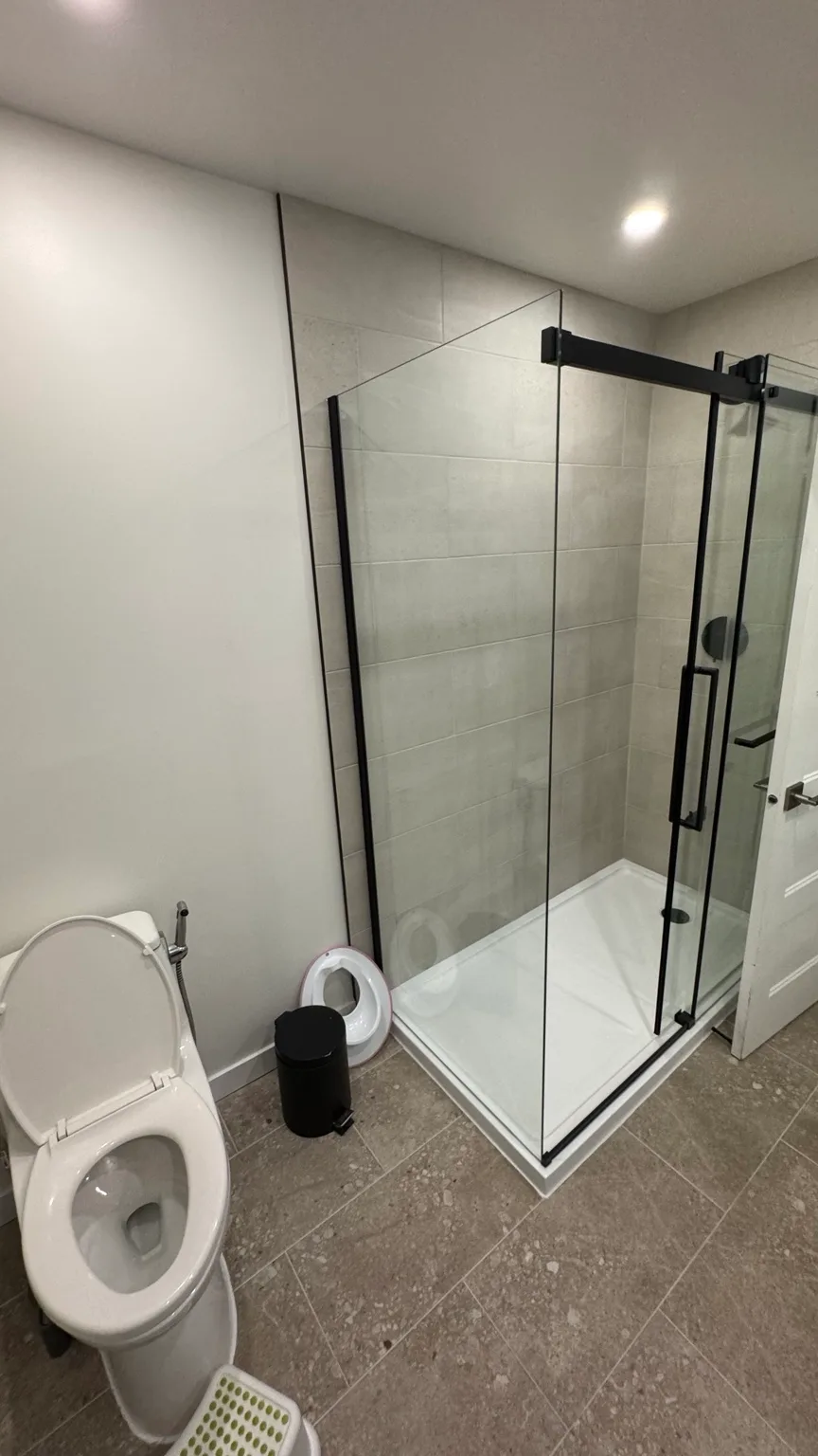 Overall view of the renovated bathroom and laundry room after completion.